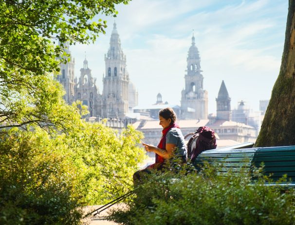 Pilgrim looking for a massage In Santiago De Compostela, The End Of The Way of St James, With Cathedral In Background.